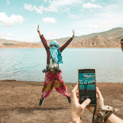 Giovanna instagramma. Adriana salta con sullo sfondo il Lago Tislit  o è L'Isli 